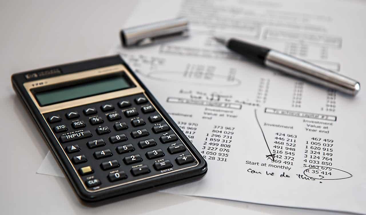 A picture of a calculator and a financial sheet meant to represent budgeting.